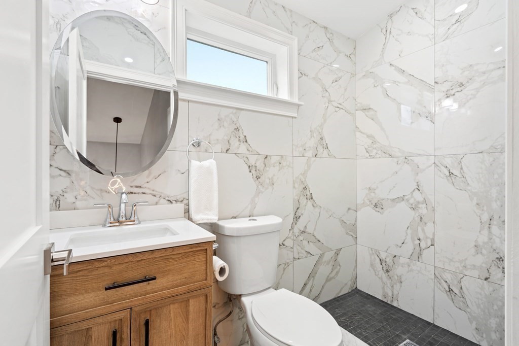 19 Cold Spring Road, Unit S North Reading, MA 01864 - Photo 21 of 30 a bathroom with a sink a toilet and a mirror
