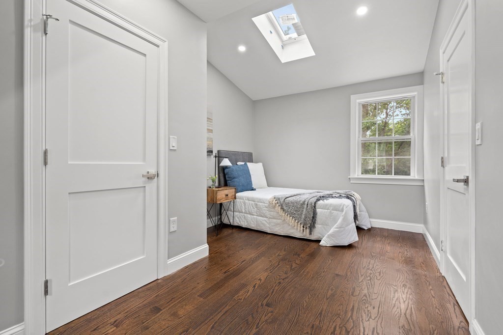 19 Cold Spring Road, Unit S North Reading, MA 01864 - Photo 22 of 30 a bedroom with a bed and wooden floor