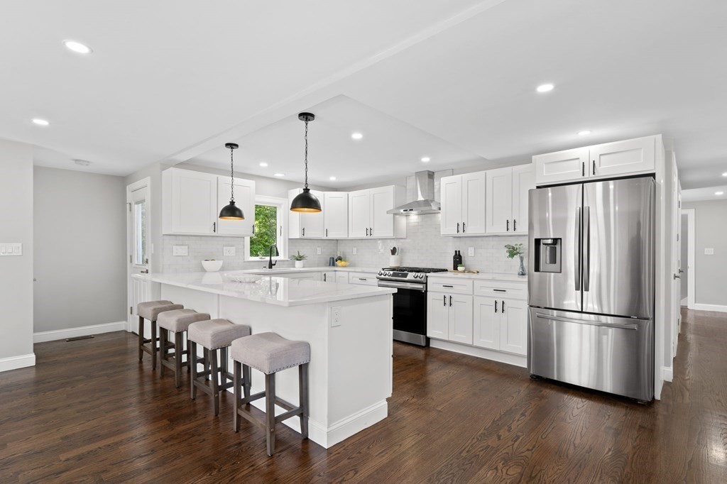 19 Cold Spring Road, Unit S North Reading, MA 01864 - Photo 5 of 30 a kitchen with stainless steel appliances a refrigerator a stove a sink and chairs