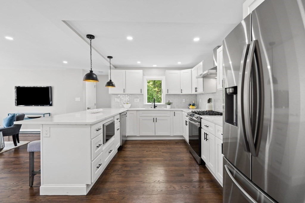19 Cold Spring Road, Unit S North Reading, MA 01864 - Photo 6 of 30 a kitchen with white cabinets and stainless steel appliances