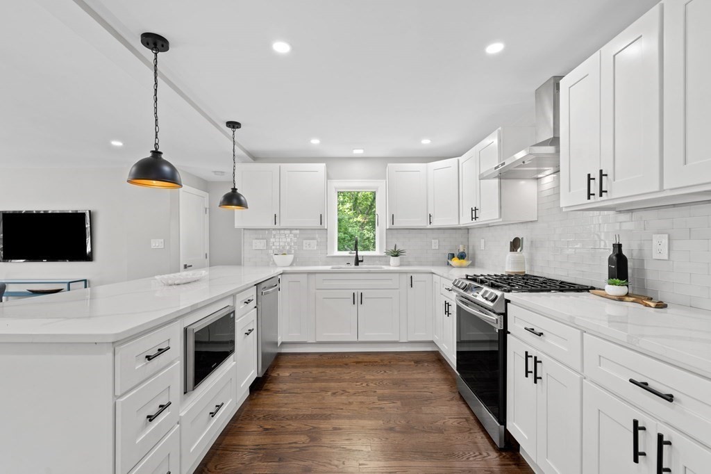 19 Cold Spring Road, Unit S North Reading, MA 01864 - Photo 7 of 30 a kitchen with a stove sink and a microwave