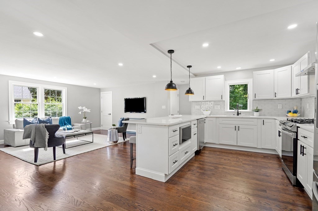 19 Cold Spring Road, Unit S North Reading, MA 01864 - Photo 9 of 30 a open kitchen with white cabinets and wooden floor