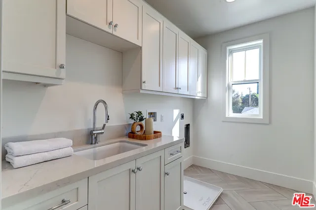 a kitchen with a sink cabinets and a window