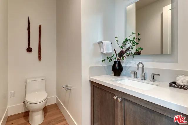 a bathroom with a sink a toilet and mirror