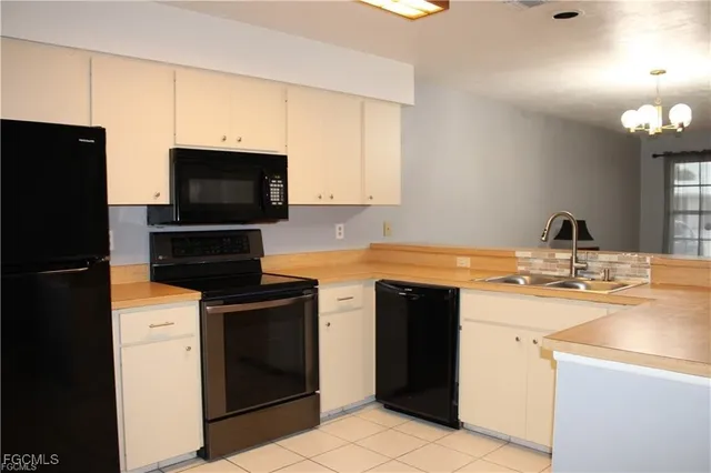 a kitchen with stainless steel appliances a stove microwave and refrigerator