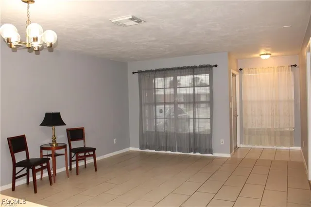a view of a livingroom with a furniture wooden floor and a chandelier