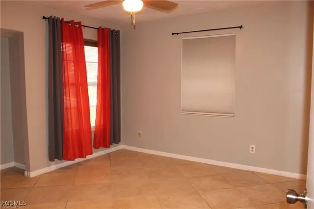 a view of a room with window and a chandelier fan