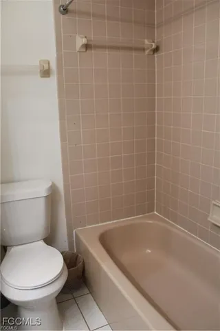a white bath tub sitting next to a toilet