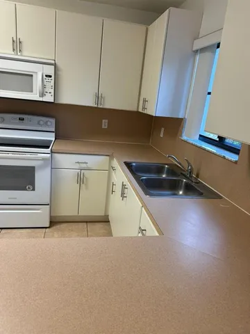 a kitchen with a sink and a stove