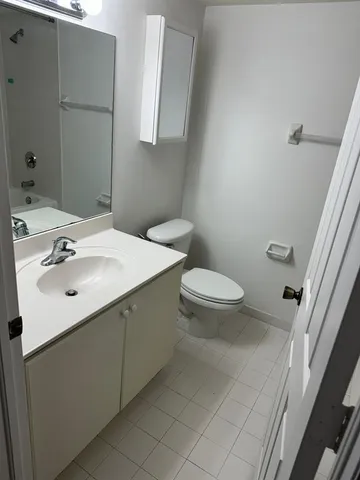 a bathroom with a sink toilet and mirror