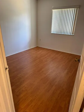 an empty room with wooden floor