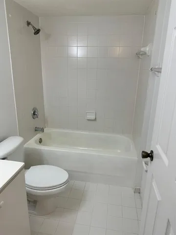 a bathroom with a toilet and a bath tub