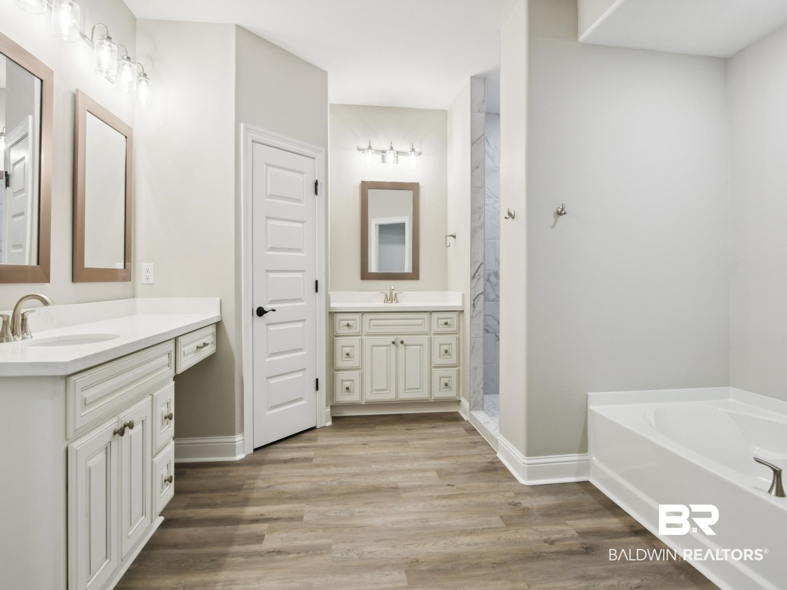 23937 Peppermint Street Elberta, AL 36530 - Photo 11 of 22 Bathroom with two vanities, a garden tub, wood finished floors, and a walk in shower