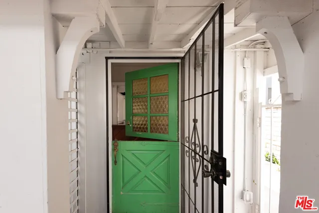 a view of a patio with table and chairs potted plants