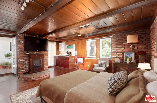 a bed room with furniture and a flat screen tv