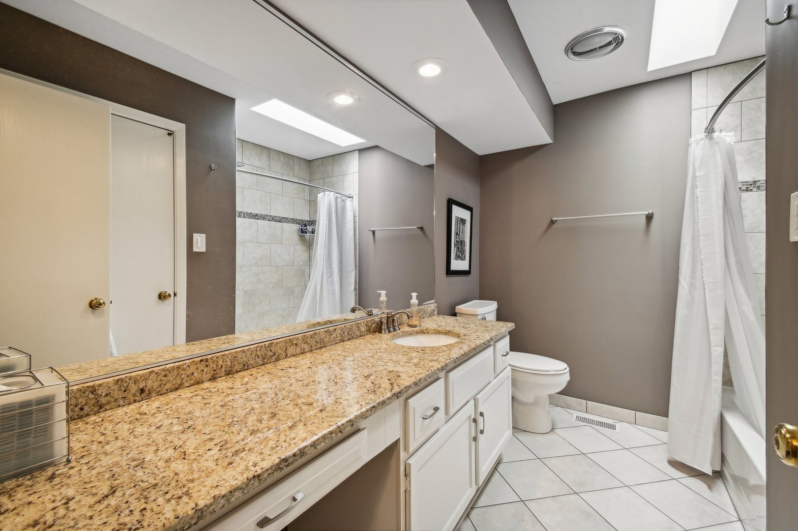 1551 Winnetka Road Glenview, IL 60025 - Photo 13 of 28 a bathroom with a granite countertop sink a toilet and a shower
