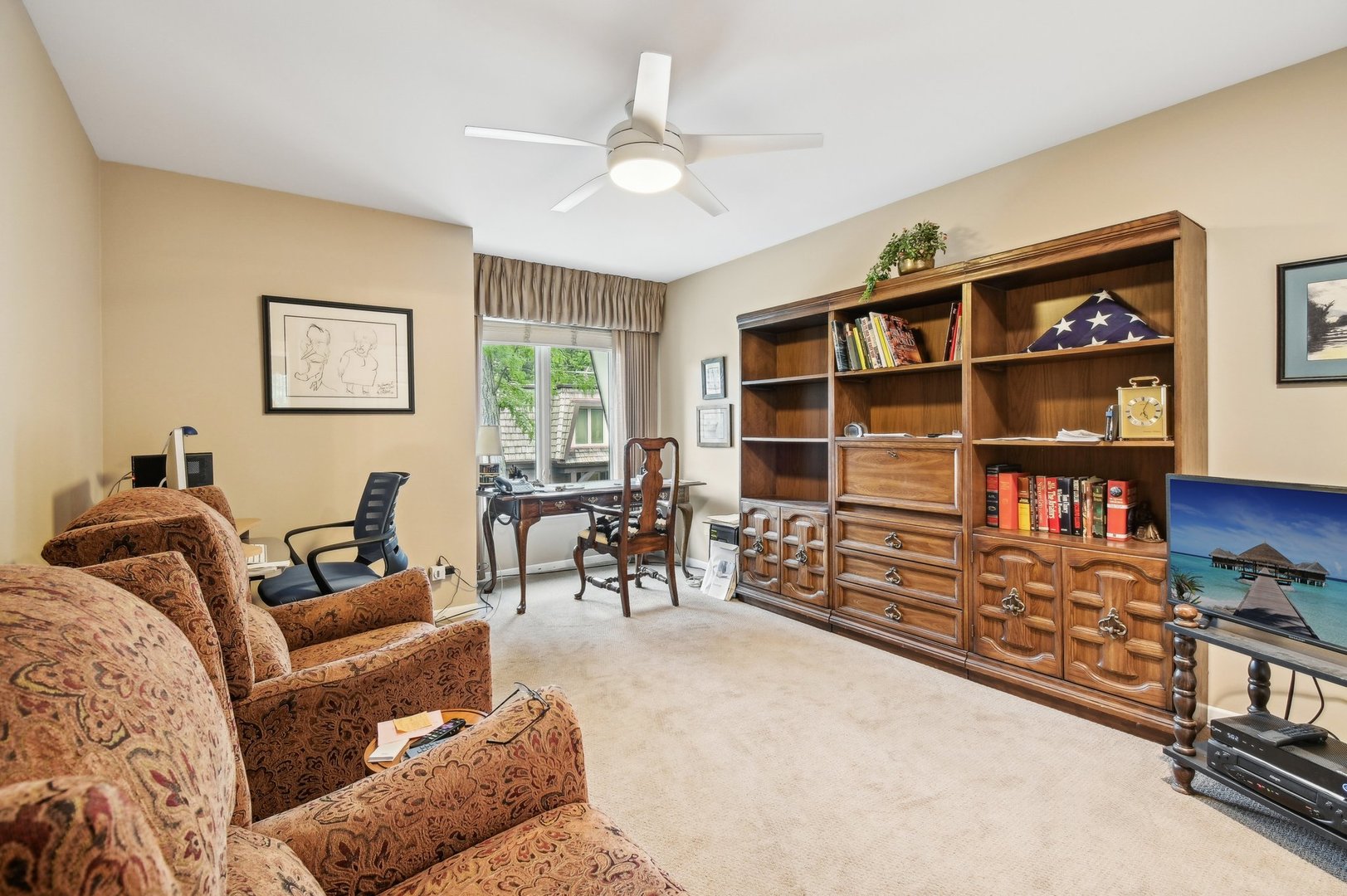 1551 Winnetka Road Glenview, IL 60025 - Photo 14 of 28 a living room with furniture a rug and a bookshelf