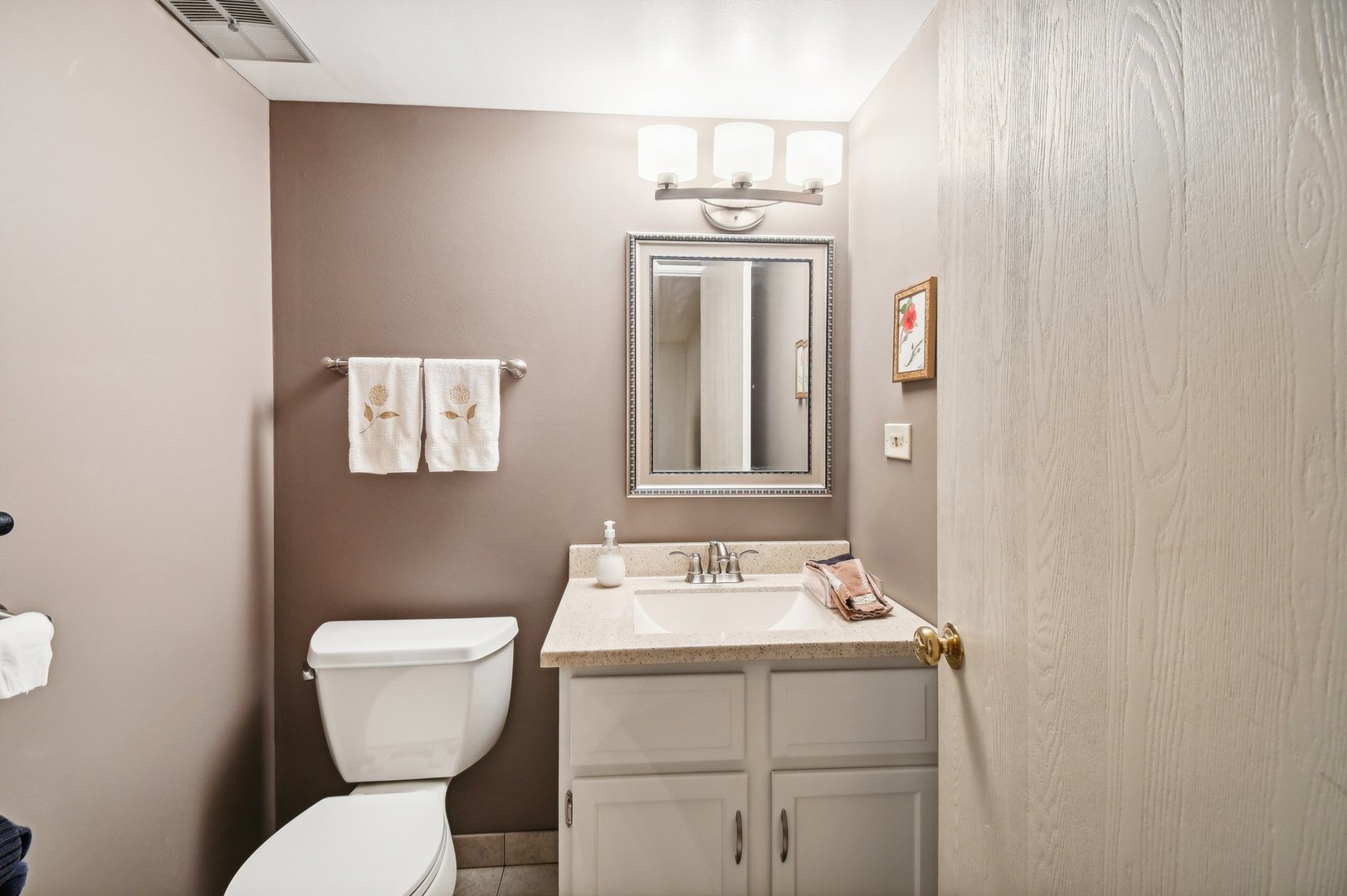 1551 Winnetka Road Glenview, IL 60025 - Photo 21 of 28 a bathroom with a toilet sink and mirror