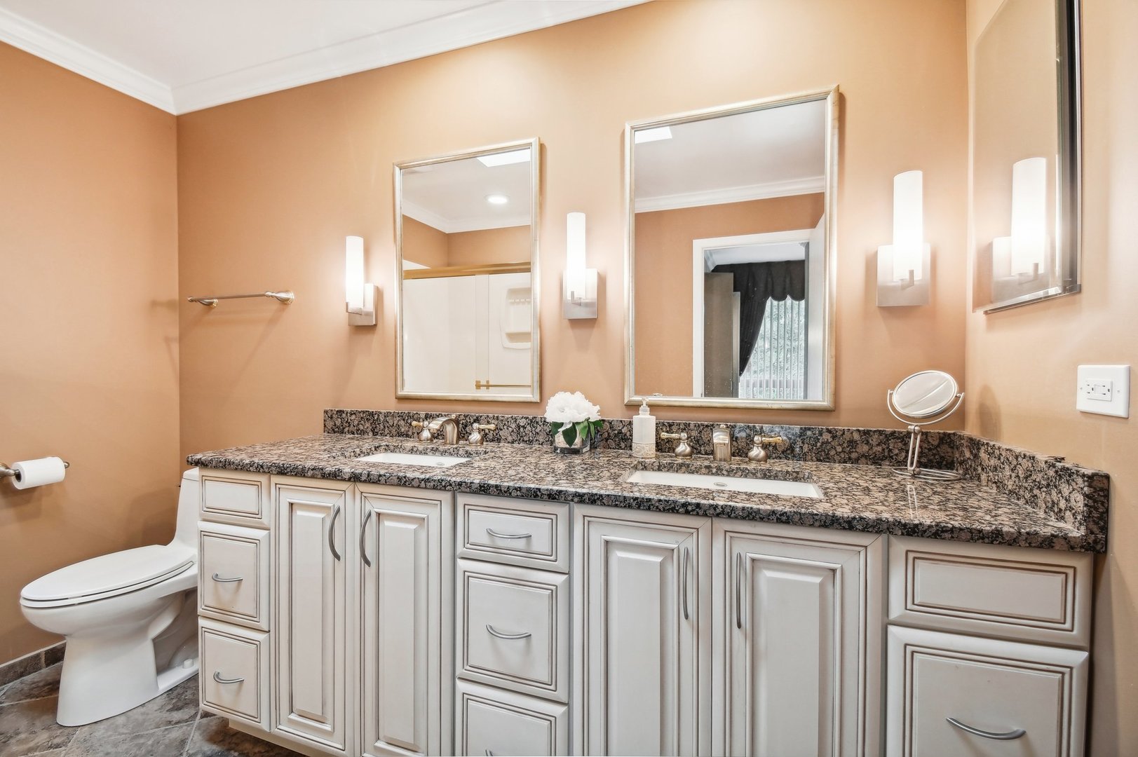 1551 Winnetka Road Glenview, IL 60025 - Photo 9 of 28 a bathroom with a granite countertop toilet sink and mirror