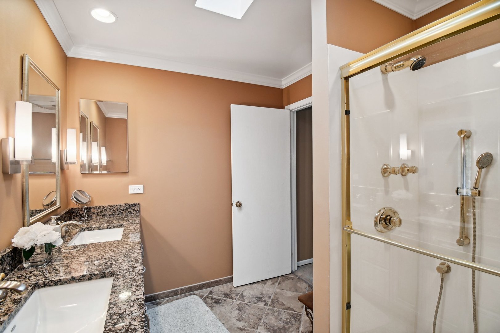 1551 Winnetka Road Glenview, IL 60025 - Photo 10 of 28 a bathroom with a granite countertop sink a mirror and shower
