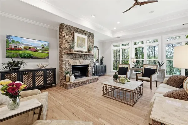 a living room with furniture a flat screen tv and a fireplace