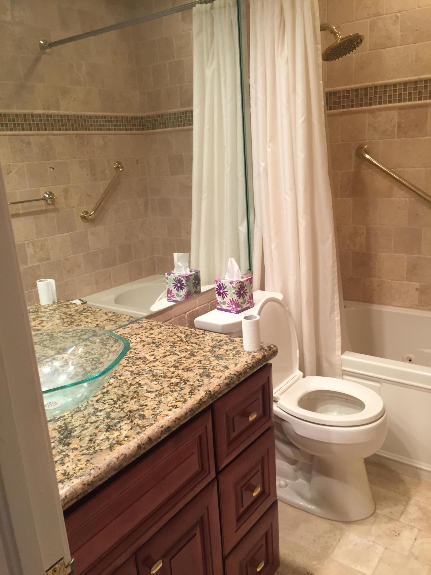 1200 Southwest 15th Street Boca Raton, FL 33486 - Photo 13 of 18 a bathroom with a granite countertop sink and a toilet