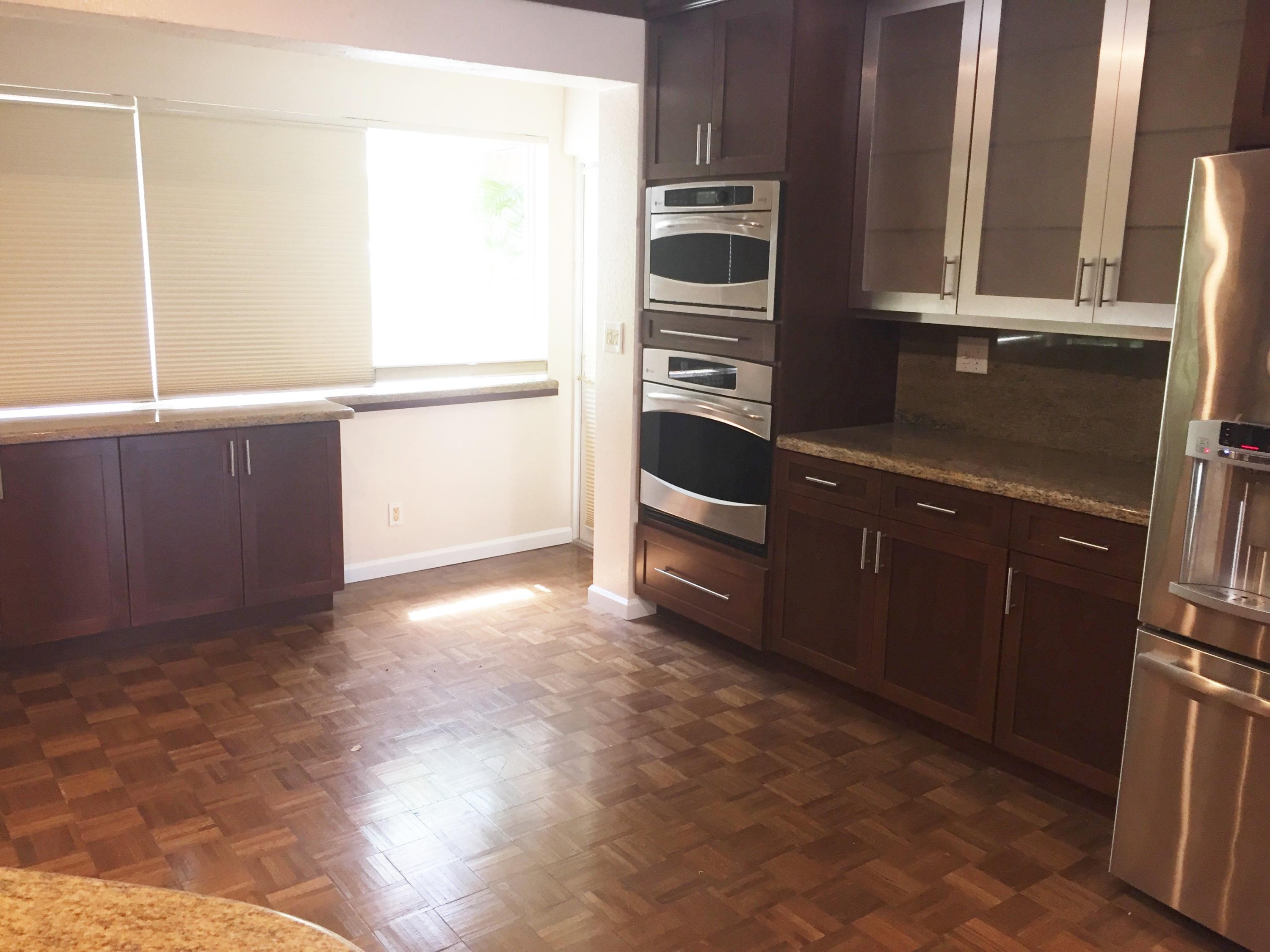 1200 Southwest 15th Street Boca Raton, FL 33486 - Photo 4 of 18 a kitchen with granite countertop a refrigerator and a stove