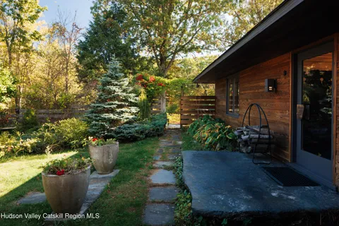 a room with lots of white walls and a painting on the wall
