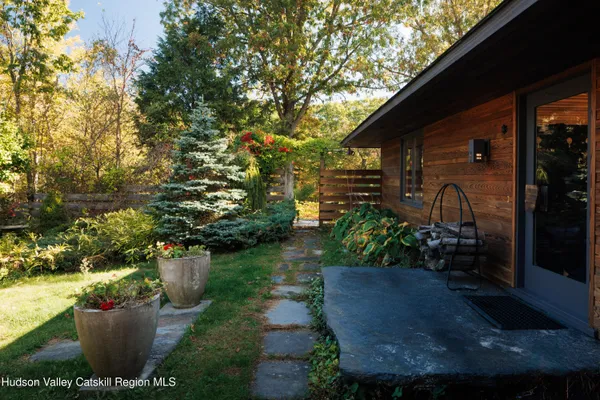 a room with lots of white walls and a painting on the wall