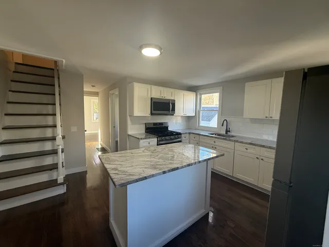 a kitchen with a stove a sink and a refrigerator