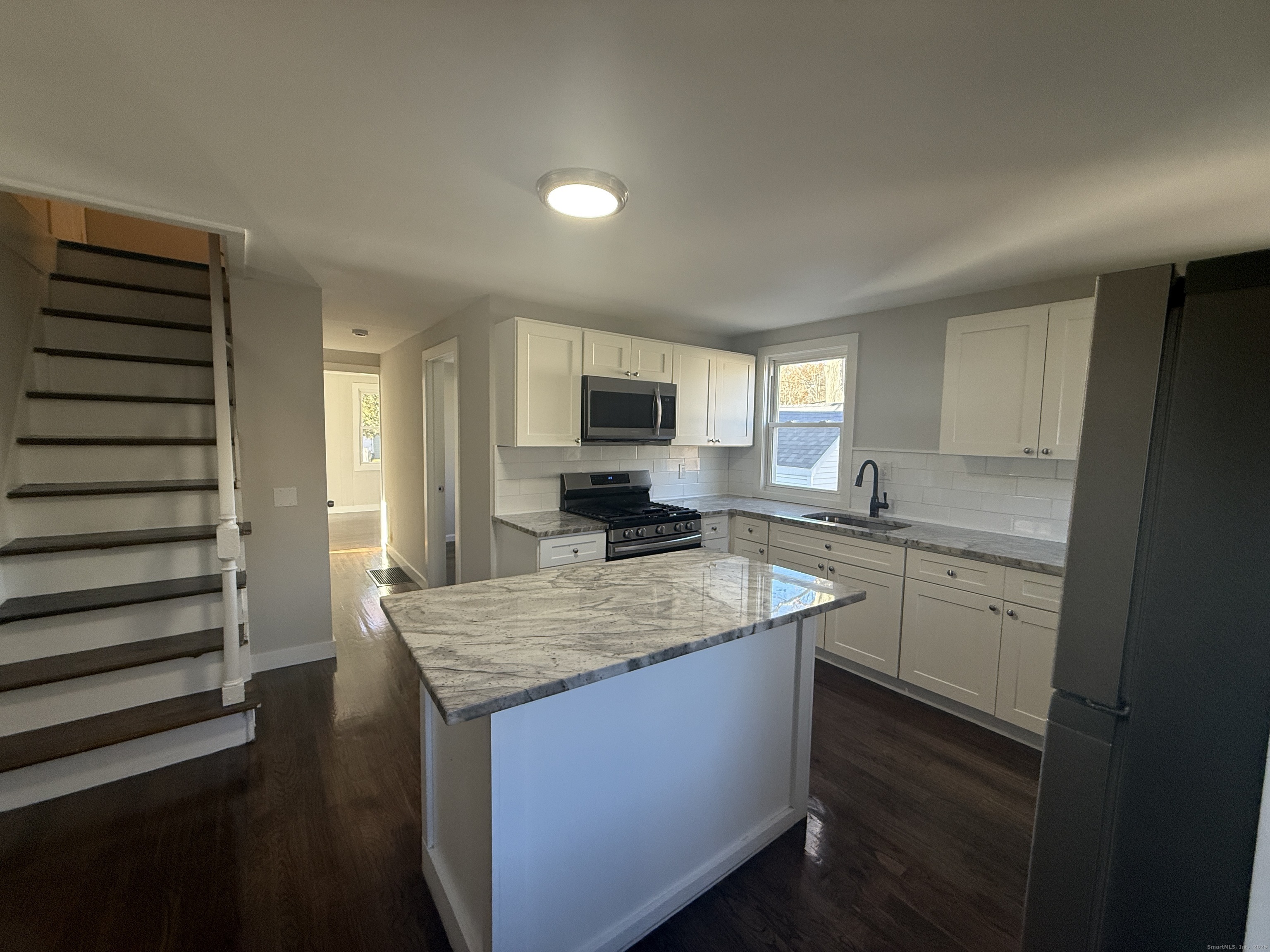a kitchen with a stove a sink and a refrigerator