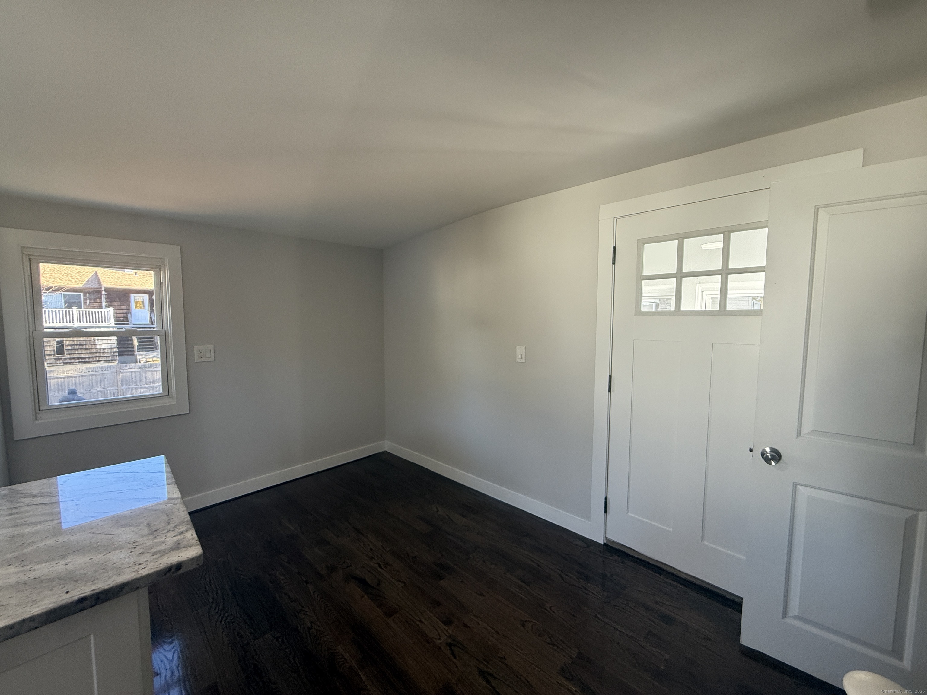 55 Ownly Avenue West Haven, CT 06516 - Photo 12 of 16 an empty room with wooden floor and windows
