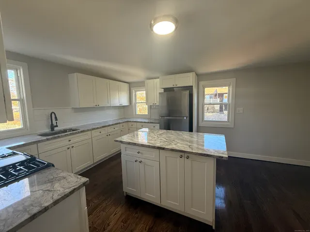 a kitchen with a sink stove and cabinets