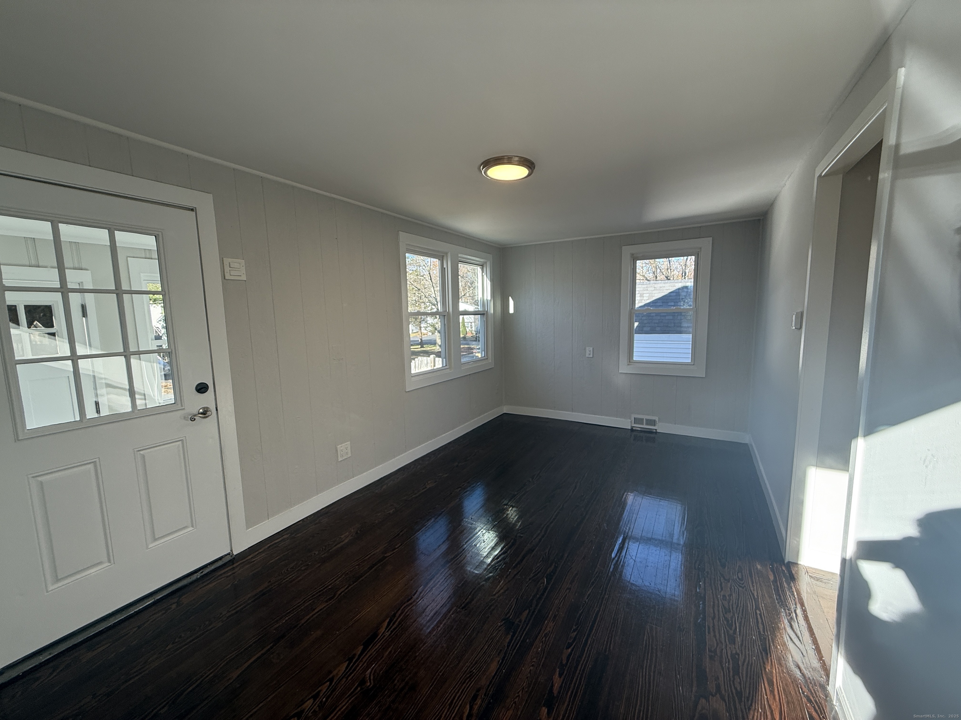 55 Ownly Avenue West Haven, CT 06516 - Photo 4 of 16 a view of an empty room with wooden floor and a window