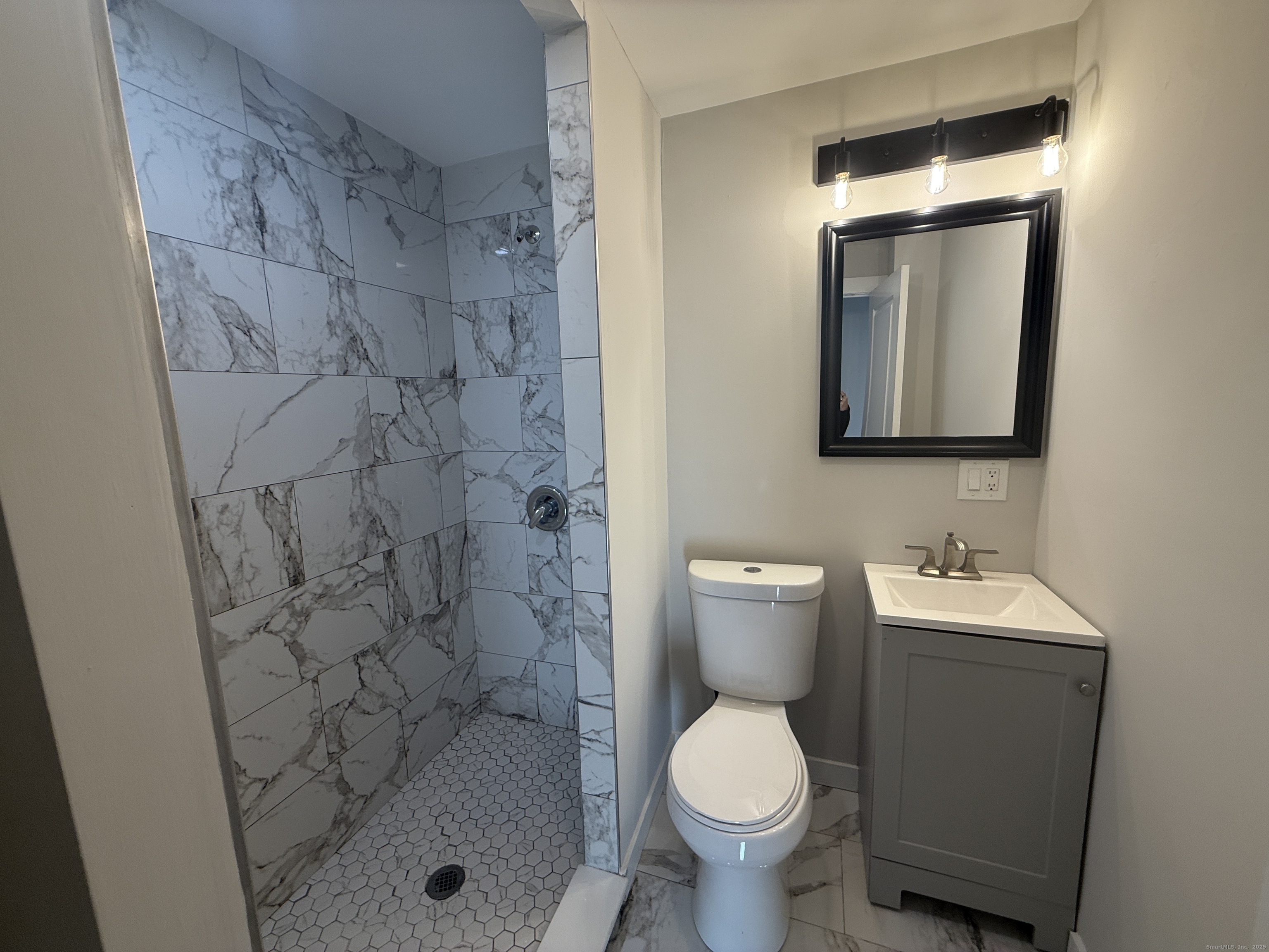 55 Ownly Avenue West Haven, CT 06516 - Photo 5 of 16 a bathroom with a toilet sink and mirror