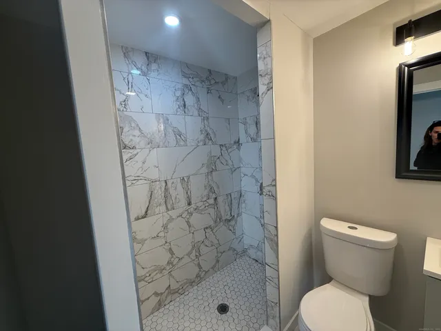 a bathroom with a toilet and a shower