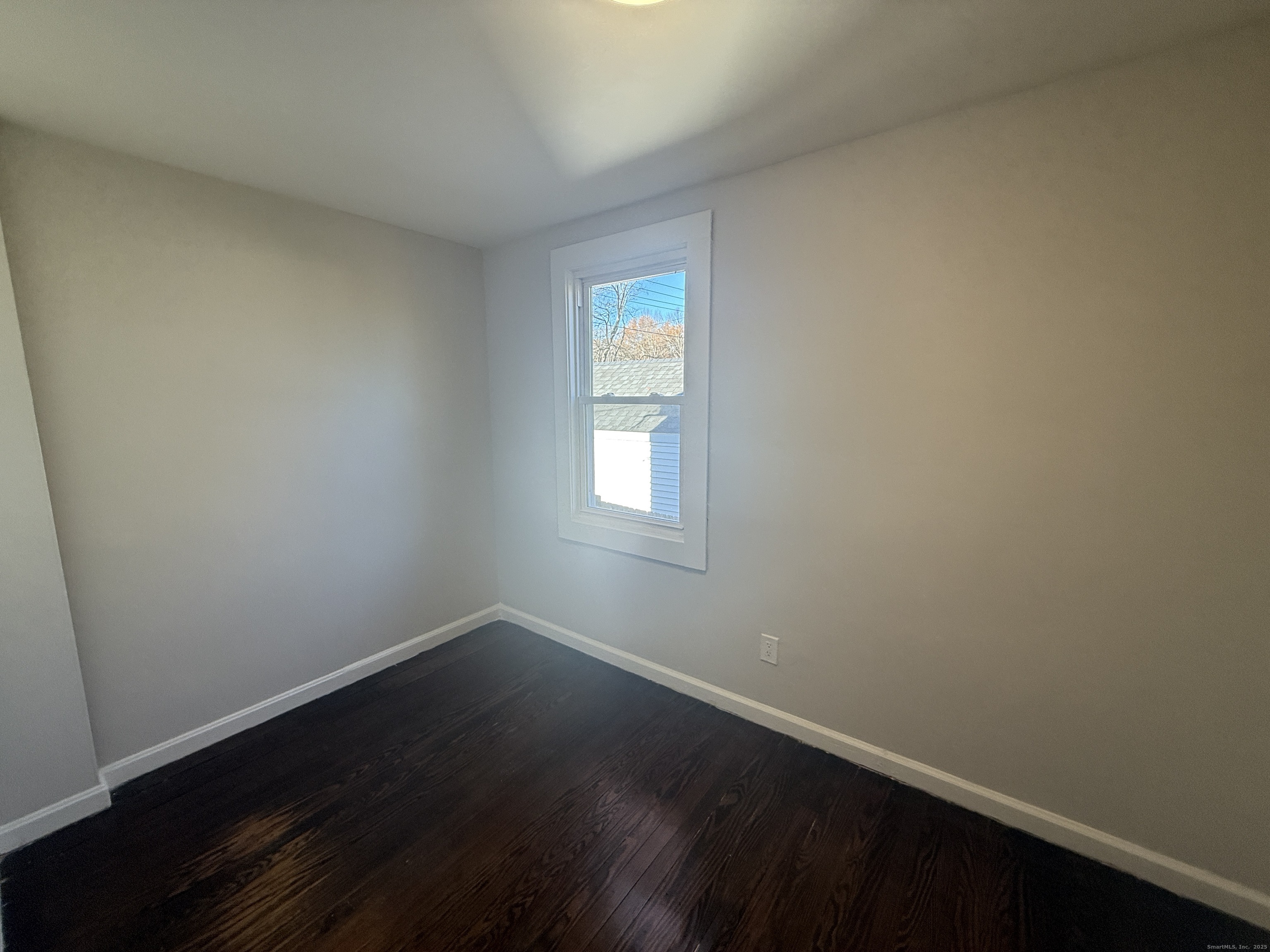 55 Ownly Avenue West Haven, CT 06516 - Photo 7 of 16 an empty room with wooden floor and windows