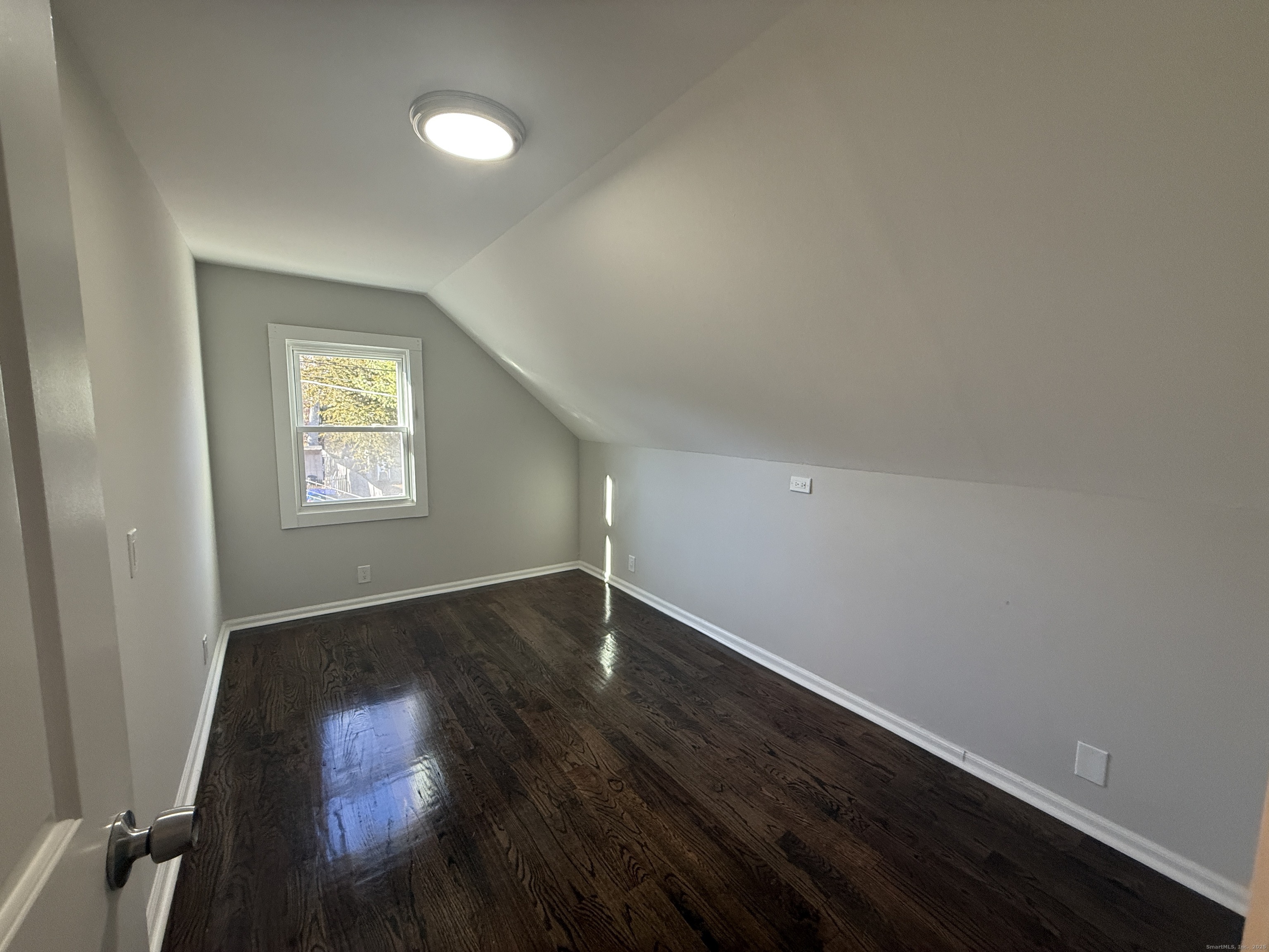 55 Ownly Avenue West Haven, CT 06516 - Photo 9 of 16 an empty room with wooden floor and windows