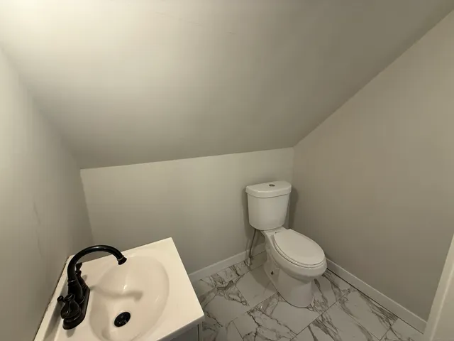 a bathroom with a toilet and a sink