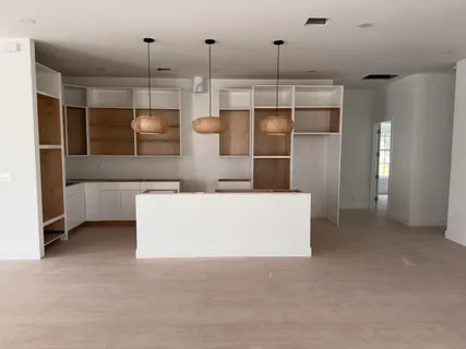 a living room with stainless steel appliances kitchen island furniture and refrigerator