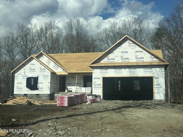 173 Divide Trail, Unit 217 Monterey, TN 38574 - Photo 1 of 1 a front view of a house with a yard and garage