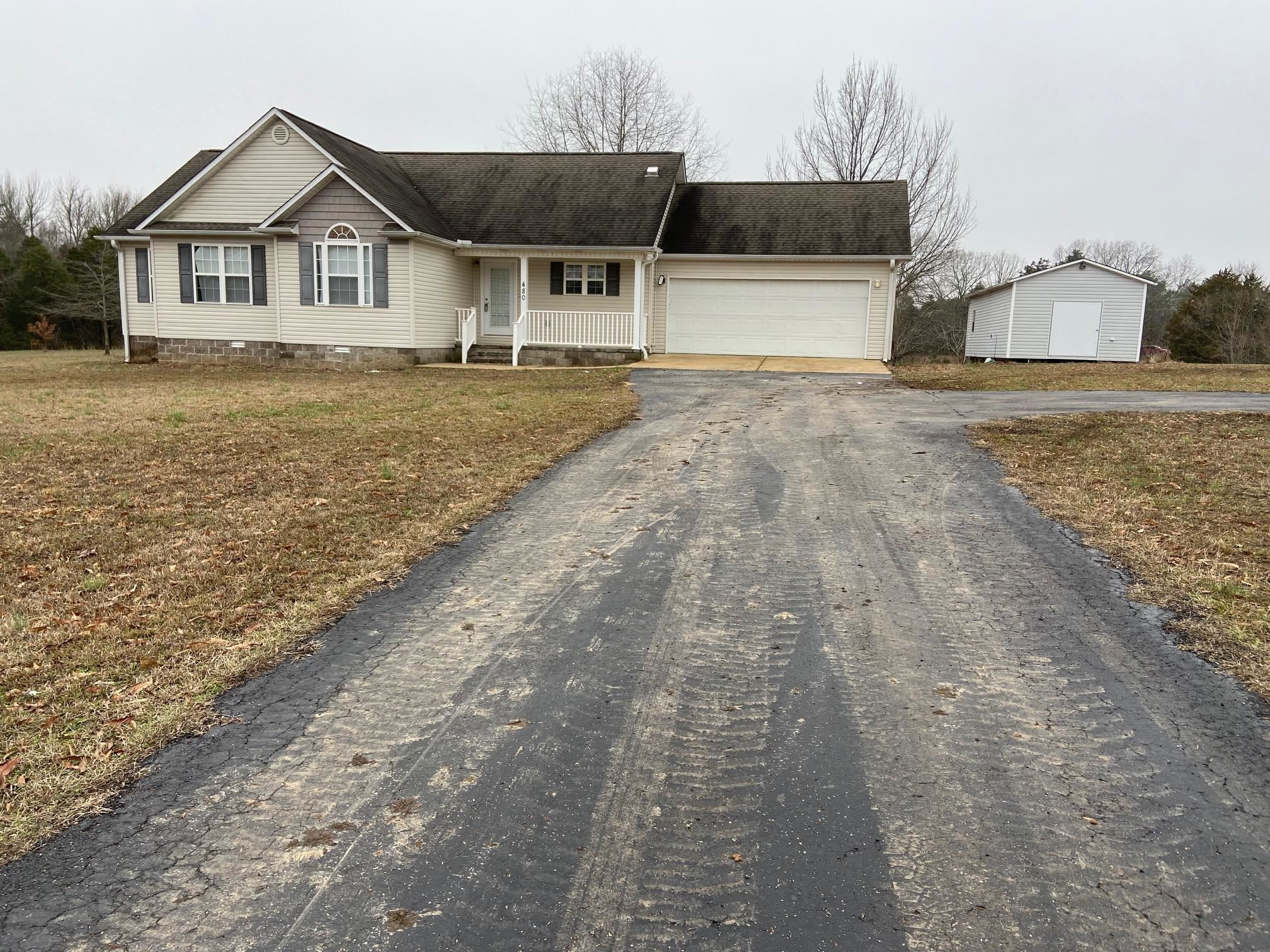 480 Enville Road Henderson, TN 38340 - Photo 1 of 35 a front view of a house with a yard and garage