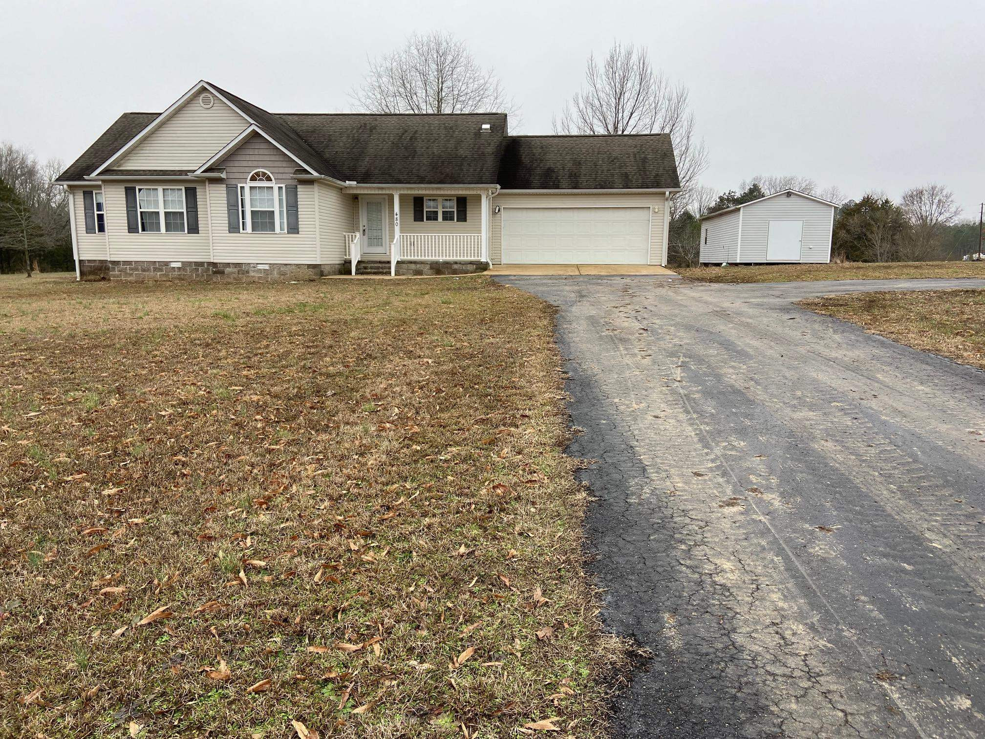 480 Enville Road Henderson, TN 38340 - Photo 33 of 35 a front view of a house with a yard and garage