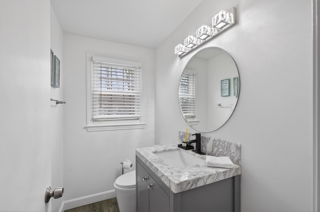 15 Cedar Square, Unit 15 Millis, MA 02054 - Photo 11 of 42 a bathroom with a granite countertop toilet a sink and a mirror