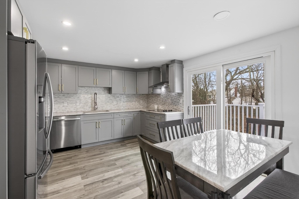 15 Cedar Square, Unit 15 Millis, MA 02054 - Photo 13 of 42 a kitchen with granite countertop a sink stainless steel appliances and white cabinets