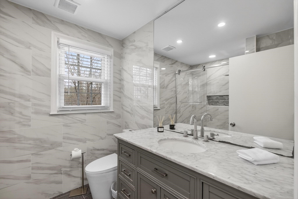 15 Cedar Square, Unit 15 Millis, MA 02054 - Photo 17 of 42 a bathroom with a granite countertop sink a toilet and a mirror