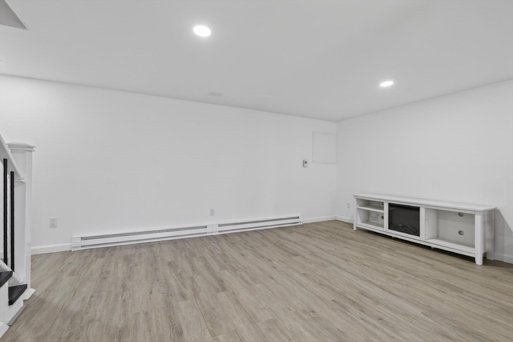15 Cedar Square, Unit 15 Millis, MA 02054 - Photo 29 of 42 an empty room with wooden floor and windows