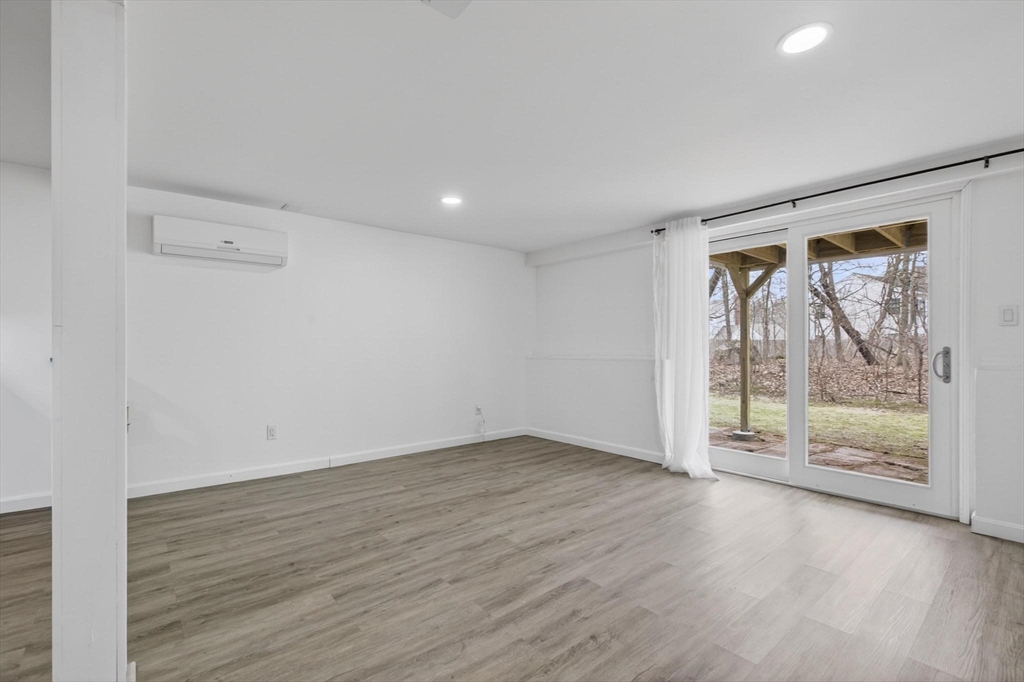 15 Cedar Square, Unit 15 Millis, MA 02054 - Photo 30 of 42 an empty room with wooden floor and windows