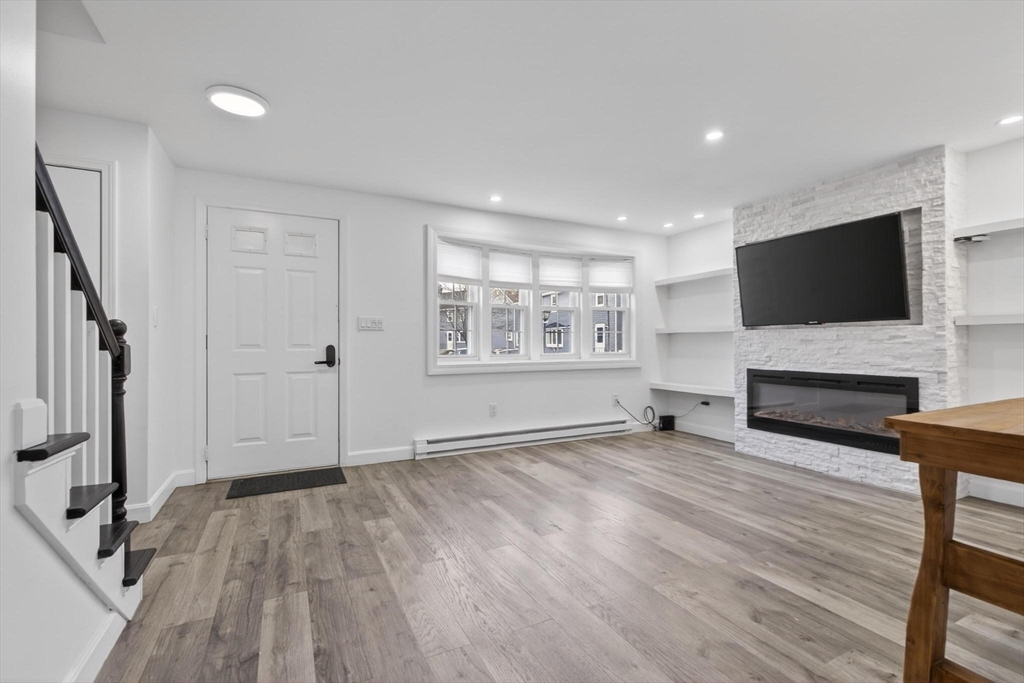 15 Cedar Square, Unit 15 Millis, MA 02054 - Photo 5 of 42 a view of a livingroom with wooden floor and a flat screen tv