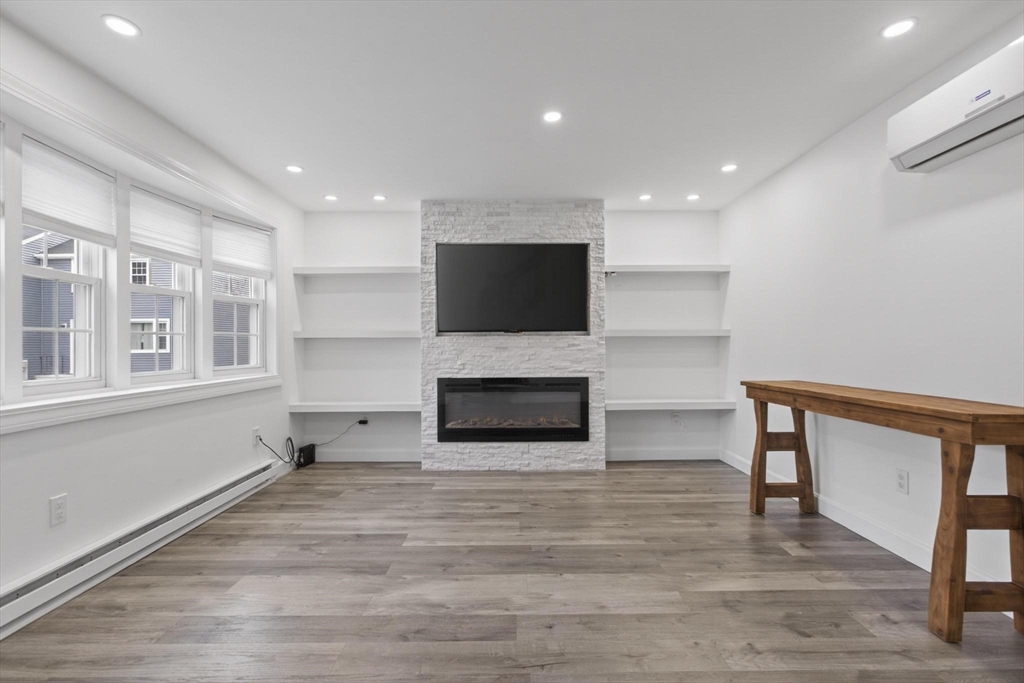 15 Cedar Square, Unit 15 Millis, MA 02054 - Photo 7 of 42 a living room with fireplace furniture and a flat screen tv